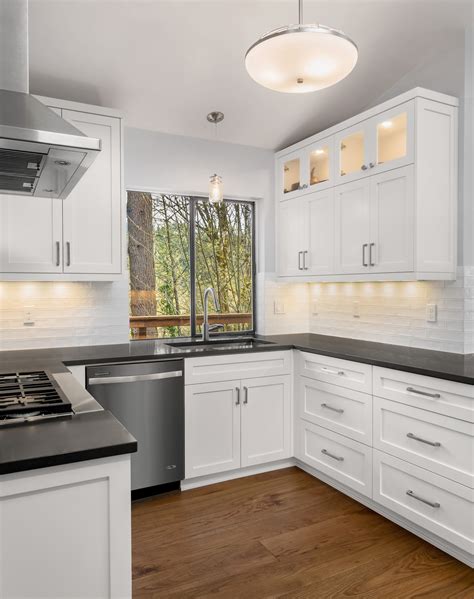 white cabinets with black backsplash